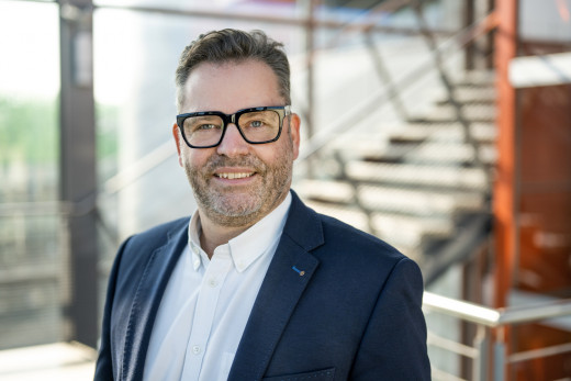 Businessportrait eines Geschäftsführers vor einen modernem Treppenhaus