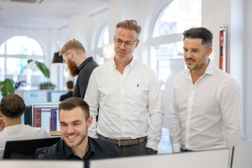 Kollegen unterhalten sich über ein Projekt am Schreibtisch